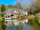 Stately brick home with a gazebo overlooking a tranquil pond, creating a serene waterfront oasis at 6000 E Andechs Smt, Johns Creek, GA 30097
