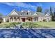 Inviting brick home featuring a manicured lawn and classic architectural details, creating curb appeal at 6000 E Andechs Smt, Johns Creek, GA 30097