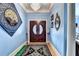 Elegant foyer featuring a chandelier, hardwood floors, and double doors creating a grand entrance at 6000 E Andechs Smt, Johns Creek, GA 30097