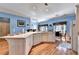 Bright kitchen featuring an island, white cabinetry, and hardwood floors providing a functional space at 6000 E Andechs Smt, Johns Creek, GA 30097