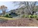 Scenic view of community pond with waterfall feature and mature trees surrounding the upscale homes at 6000 E Andechs Smt, Johns Creek, GA 30097