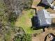 Aerial view of spacious fenced backyard, lush lawn, with a deck, and mature trees at 7335 Treyland Ct, Cumming, GA 30041