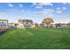 Wide-open backyard with green lawn featuring views of the house, trees, and surrounding neighborhood at 2759 Porches Ln, Dacula, GA 30019