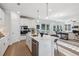 Bright, airy kitchen with white cabinetry, center island, stainless steel appliances, and open layout to the living room at 2759 Porches Ln, Dacula, GA 30019