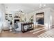 Sun-drenched living room with hardwood floors, a fireplace, built-in shelving, and lots of natural light at 2759 Porches Ln, Dacula, GA 30019
