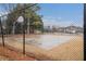 Community basketball court with two hoops, surrounded by trees and fencing at 5053 Kingsbridge Pass, Powder Springs, GA 30127