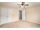 Bedroom includes neutral carpet, ceiling fan and a double door closet for ample storage at 5053 Kingsbridge Pass, Powder Springs, GA 30127