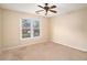 Bedroom featuring a ceiling fan and a double window overlooking a lush, green lawn at 5053 Kingsbridge Pass, Powder Springs, GA 30127