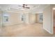 Large main bedroom boasts a tray ceiling, ceiling fan, and many windows at 5053 Kingsbridge Pass, Powder Springs, GA 30127