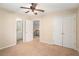 Bedroom with neutral carpet, ceiling fan, and access to the bathroom and hallway at 5053 Kingsbridge Pass, Powder Springs, GA 30127