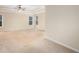 Well-lit main bedroom featuring neutral walls, trim, and carpet at 5053 Kingsbridge Pass, Powder Springs, GA 30127
