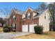 Side view of a two-story home with brick and siding and an attached garage at 5053 Kingsbridge Pass, Powder Springs, GA 30127