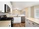 White kitchen cabinets with stainless appliances and granite countertops, adjoining breakfast area at 5053 Kingsbridge Pass, Powder Springs, GA 30127