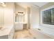 Bright main bathroom featuring a soaking tub, glass shower, and double vanity at 5053 Kingsbridge Pass, Powder Springs, GA 30127