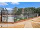 Fenced community tennis courts next to a sidewalk and landscaped areas at 5053 Kingsbridge Pass, Powder Springs, GA 30127