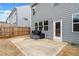 Outdoor patio area with comfortable seating, a door to the home, and a well-maintained fence at 614 Edgemore Rd, Canton, GA 30114