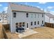 Exterior view of the home featuring a patio and spacious backyard with a wooden fence at 614 Edgemore Rd, Canton, GA 30114