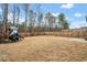 Backyard with a wood fence, an outdoor patio, a playset, and plenty of room for activities at 614 Edgemore Rd, Canton, GA 30114