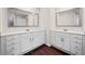 Bright bathroom featuring a double vanity with framed mirrors and sleek white countertops at 614 Edgemore Rd, Canton, GA 30114