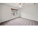 Comfortable carpeted bedroom features a ceiling fan and natural light from the window at 614 Edgemore Rd, Canton, GA 30114