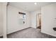 Cozy bedroom with neutral walls, plush carpet, a window, and a doorway to the bathroom at 614 Edgemore Rd, Canton, GA 30114