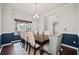 Elegant dining room featuring hardwood floors, large window, and seating for eight at 614 Edgemore Rd, Canton, GA 30114