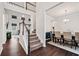 Inviting entryway featuring a staircase, hardwood floors, and a view into the dining room at 614 Edgemore Rd, Canton, GA 30114