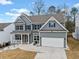 Charming two-story home with blue shutters and a well-manicured front yard at 614 Edgemore Rd, Canton, GA 30114