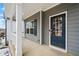 Inviting front porch with a blue front door, white columns, and manicured landscaping at 614 Edgemore Rd, Canton, GA 30114