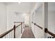 Bright upstairs hallway featuring wood railings, neutral walls and access to bedrooms and baths at 614 Edgemore Rd, Canton, GA 30114
