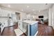 Open kitchen concept with a kitchen island, stainless steel appliances, and a view into the living room at 614 Edgemore Rd, Canton, GA 30114