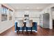 Bright kitchen showcasing an island with seating, white cabinets, and stainless steel appliances at 614 Edgemore Rd, Canton, GA 30114