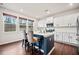 Charming kitchen with white cabinets, stainless steel appliances, a blue island, and hardwood floors at 614 Edgemore Rd, Canton, GA 30114