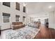 Open-concept living room with high ceilings, hardwood floors, a ceiling fan, and multiple windows at 614 Edgemore Rd, Canton, GA 30114