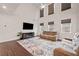 Bright living room with hardwood floors, large television, and modern electric fireplace at 614 Edgemore Rd, Canton, GA 30114