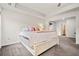 Spacious main bedroom featuring a tray ceiling, neutral decor, and an en-suite bathroom entrance at 614 Edgemore Rd, Canton, GA 30114