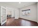 Bright office space with hardwood floors, large window, and glass french doors leading to dining area at 614 Edgemore Rd, Canton, GA 30114