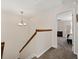 Hallway with carpet and traditional wood railing leading into the bedroom at 616 Granby Hill Pl, Alpharetta, GA 30022