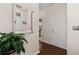 Hallway with hardwood floors, a mirror, and an open view into the kitchen at 616 Granby Hill Pl, Alpharetta, GA 30022