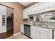 Well-lit kitchen featuring granite countertops, stainless steel dishwasher, sink, and cabinets with a view of the outside at 616 Granby Hill Pl, Alpharetta, GA 30022