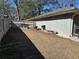 Side yard with a fenced perimeter and some discarded material visible in the background at 2408 Three Bars Dr, Snellville, GA 30078
