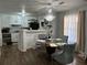Dining room featuring modern chandelier, hardwood floors and an open transition to the kitchen area at 2408 Three Bars Dr, Snellville, GA 30078