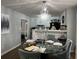 Cozy dining room with natural light, hardwood floors, chandelier, and open to the kitchen at 2408 Three Bars Dr, Snellville, GA 30078