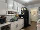 Kitchen boasts marble countertops, white cabinetry, a stainless steel sink and hardwood floors at 2408 Three Bars Dr, Snellville, GA 30078