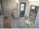 Large bathroom with double vanities, granite counters, and tile flooring at 5315 Austrian Pine Ct, Cumming, GA 30040