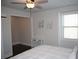 Cozy bedroom features a ceiling fan, a window with blinds, and neutral wall art at 5315 Austrian Pine Ct, Cumming, GA 30040