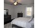 Bright bedroom with natural light, featuring a dresser, ceiling fan and plush comforter at 5315 Austrian Pine Ct, Cumming, GA 30040