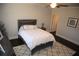 Cozy bedroom showcasing a white comforter, dark wood floors, and a ceiling fan at 5315 Austrian Pine Ct, Cumming, GA 30040