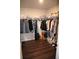 Walk-in closet offering ample storage space with dark wood floors at 5315 Austrian Pine Ct, Cumming, GA 30040