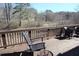 Comfortable deck area featuring wood railings and outdoor seating, perfect for enjoying the scenic view at 5315 Austrian Pine Ct, Cumming, GA 30040